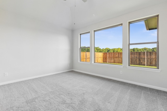 carpeted empty room featuring ceiling fan