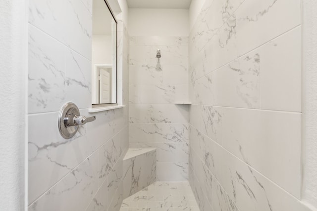 bathroom with a tile shower