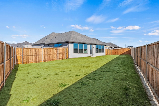 rear view of house featuring a lawn