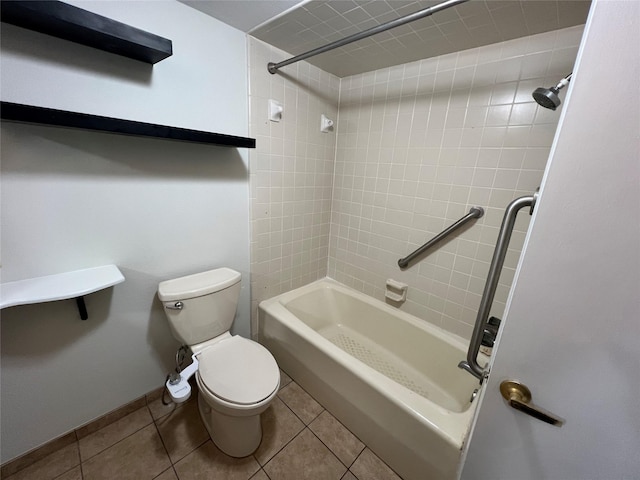 bathroom with tiled shower / bath combo, tile patterned floors, and toilet