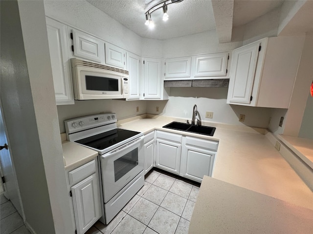 kitchen with white appliances, sink, a textured ceiling, and white cabinets