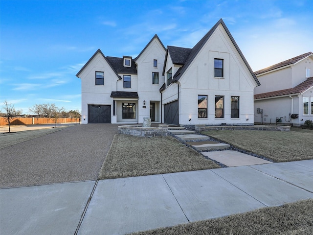 modern farmhouse featuring a garage and a front lawn