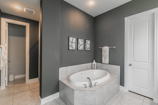 bathroom with tile patterned floors and tiled tub