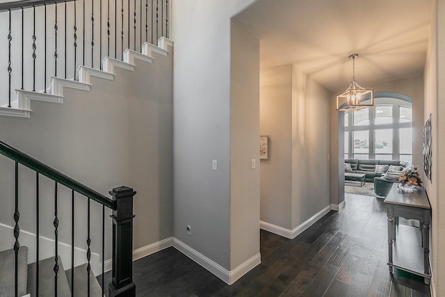 interior space featuring dark wood-type flooring and a chandelier