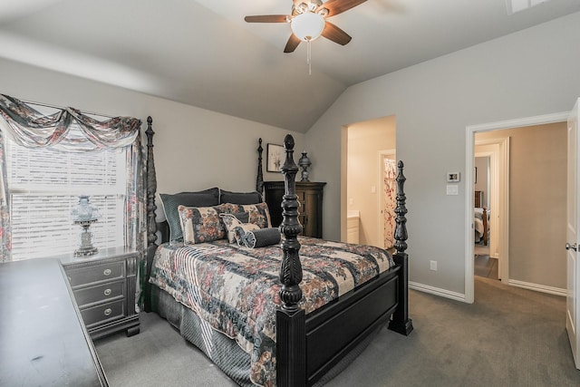 bedroom with dark colored carpet, ceiling fan, lofted ceiling, and ensuite bathroom