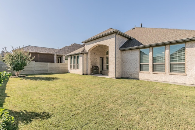 rear view of house with a lawn