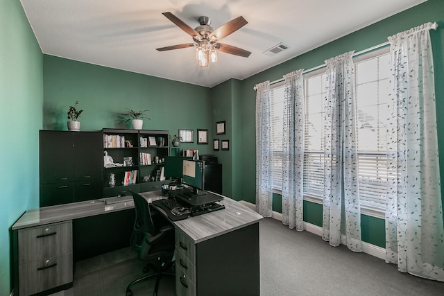 carpeted office with ceiling fan