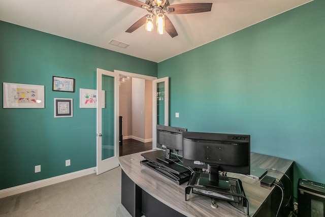 carpeted office space featuring ceiling fan and french doors