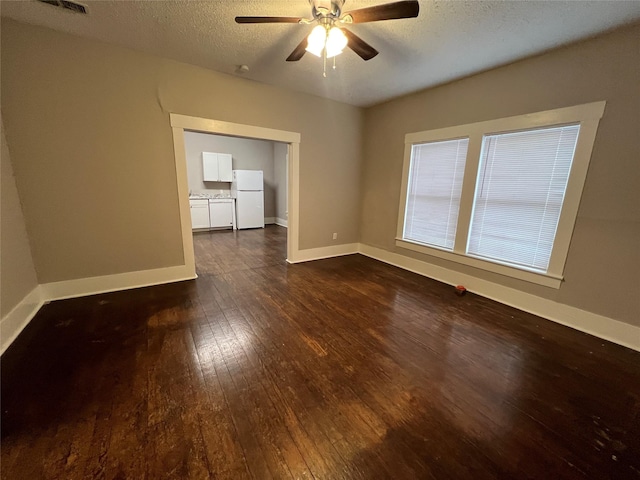 unfurnished room with dark hardwood / wood-style flooring, ceiling fan, and a textured ceiling