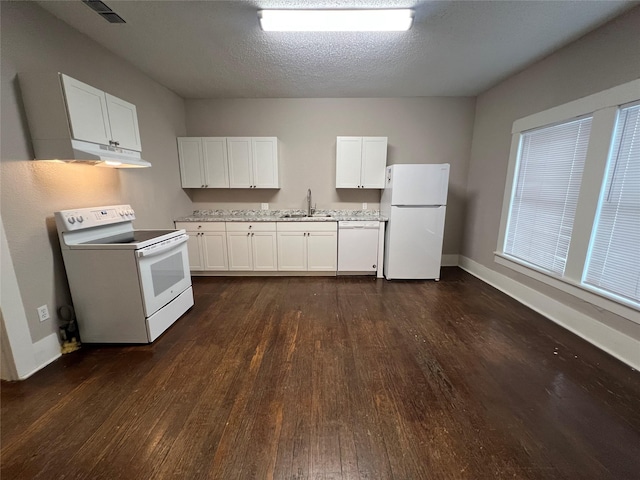 kitchen with sink, white appliances, dark wood-type flooring, and white cabinets