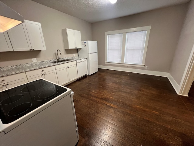 kitchen featuring sink, white cabinetry, dark hardwood / wood-style flooring, white appliances, and light stone countertops