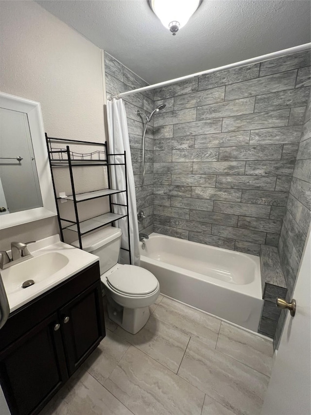 full bathroom featuring shower / tub combo, vanity, a textured ceiling, and toilet