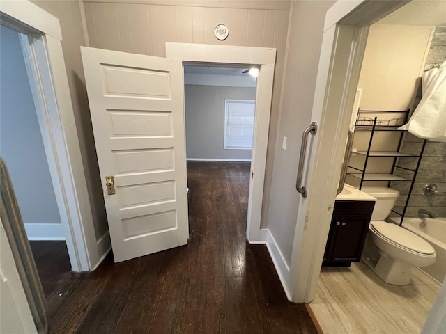 full bathroom featuring hardwood / wood-style flooring, vanity, and toilet