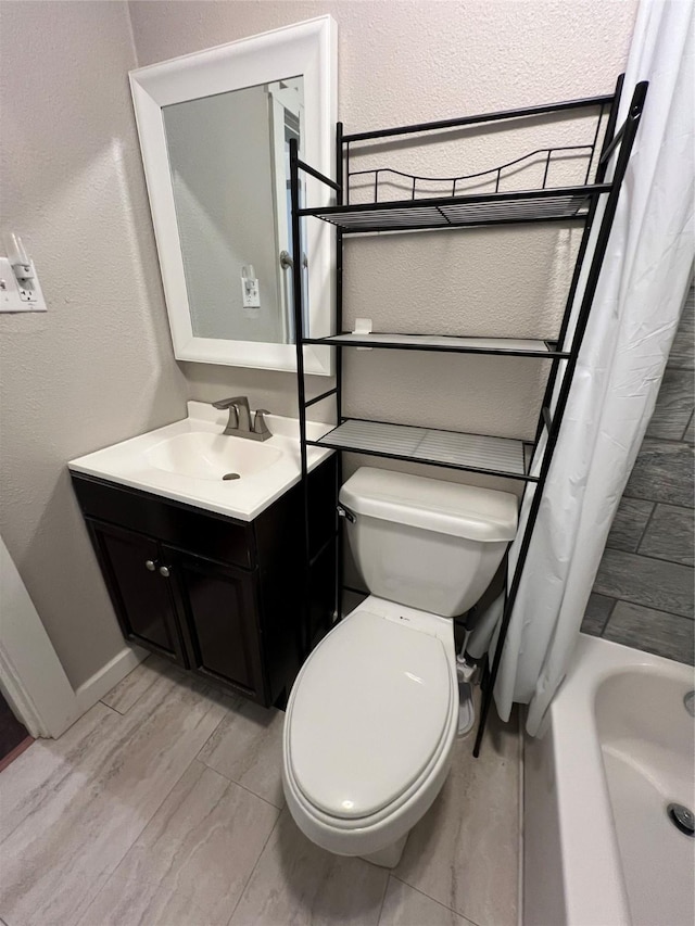 full bathroom featuring shower / bath combo, vanity, and toilet