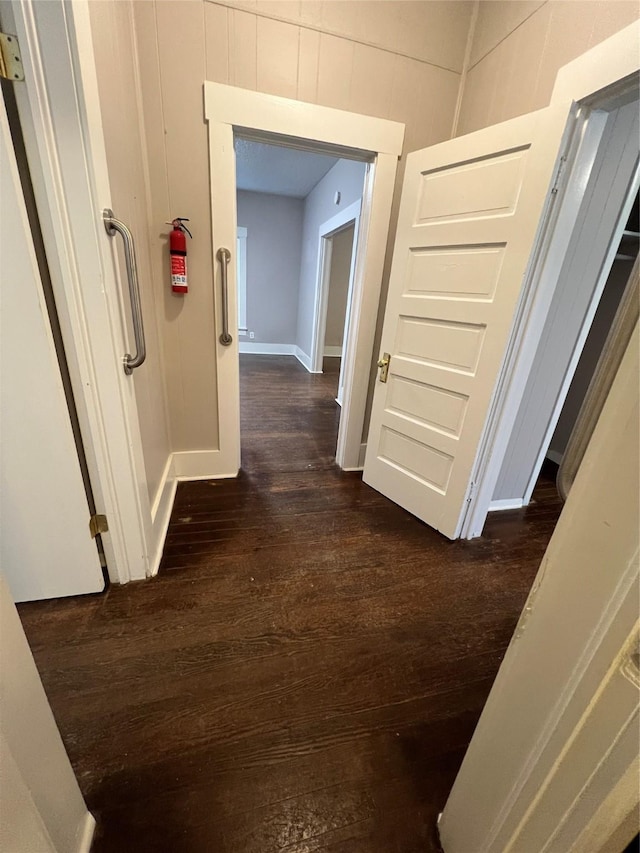 corridor featuring dark hardwood / wood-style flooring