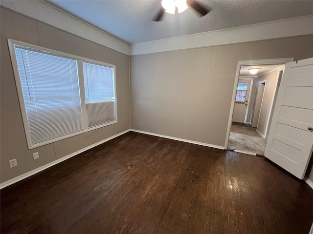 unfurnished room with dark hardwood / wood-style floors, a textured ceiling, and ceiling fan