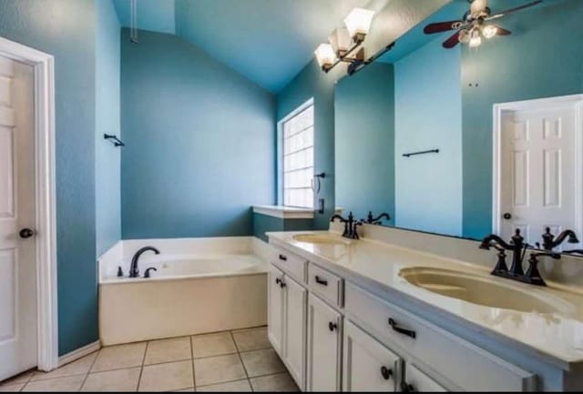 bathroom with vanity, vaulted ceiling, tile patterned flooring, ceiling fan, and a tub