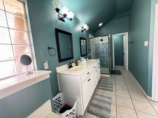 bathroom featuring tile patterned flooring, vanity, vaulted ceiling, and a shower with shower door