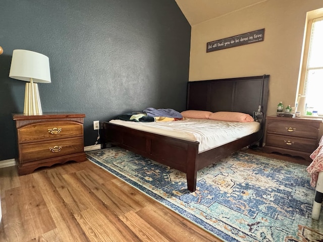 bedroom with wood-type flooring