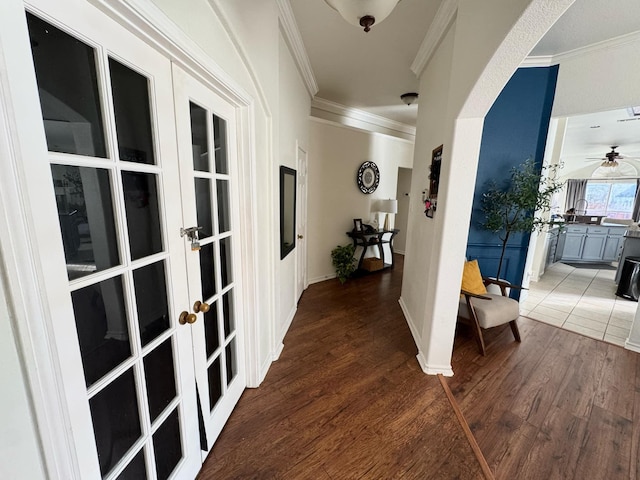 hall featuring french doors, ornamental molding, and dark wood-type flooring