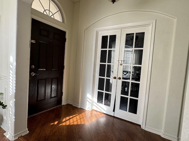 entryway with french doors and dark wood-type flooring