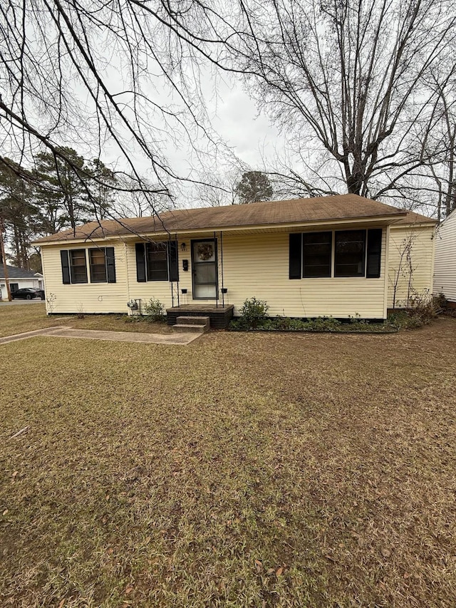 single story home featuring a front lawn