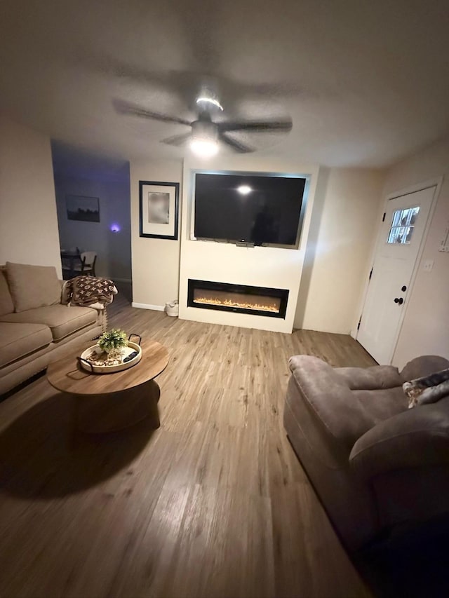 living room featuring ceiling fan and wood-type flooring