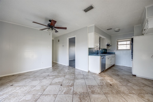 kitchen featuring sink, ceiling fan, a textured ceiling, white cabinets, and stainless steel dishwasher