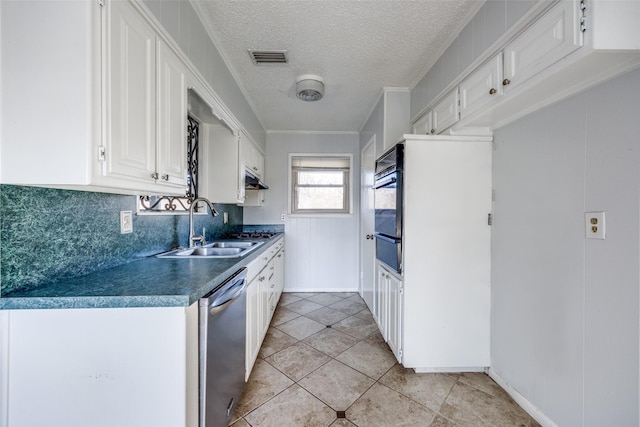 kitchen with sink, white cabinets, a textured ceiling, decorative backsplash, and stainless steel dishwasher