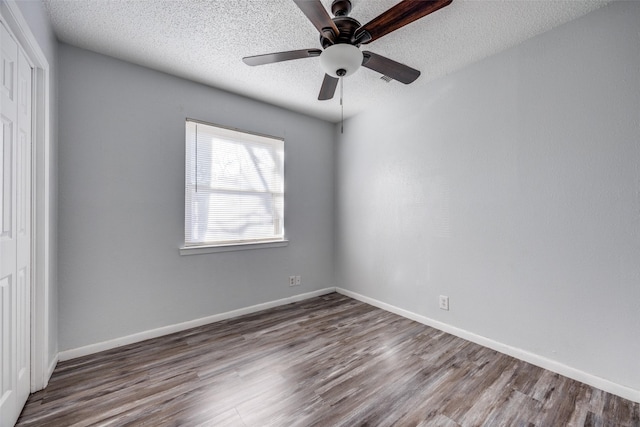 unfurnished room with ceiling fan, hardwood / wood-style floors, and a textured ceiling