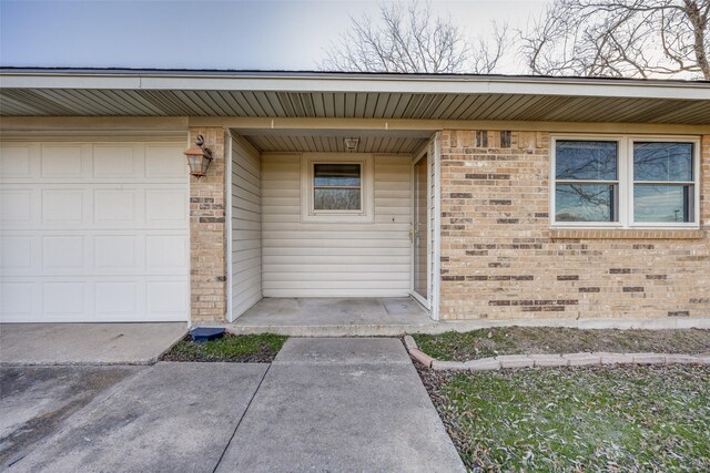 view of exterior entry featuring a garage