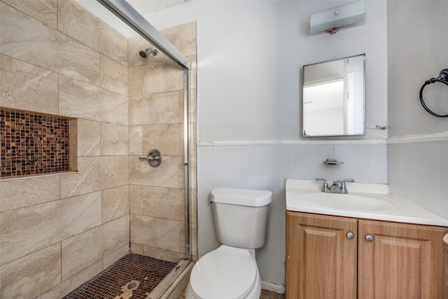 bathroom featuring vanity, toilet, and walk in shower