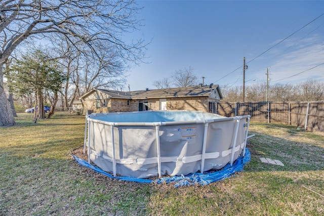 view of swimming pool with a lawn