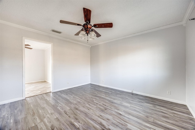 empty room featuring hardwood / wood-style flooring, ceiling fan, crown molding, and a textured ceiling