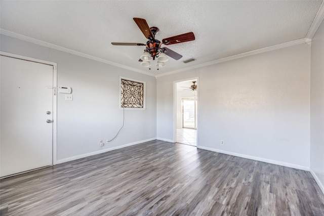 unfurnished room with hardwood / wood-style floors, ornamental molding, and a textured ceiling