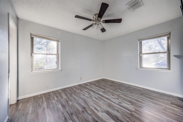 unfurnished room with ceiling fan, hardwood / wood-style flooring, a textured ceiling, and a healthy amount of sunlight