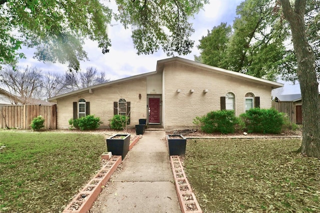 ranch-style home with a front yard