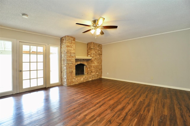 unfurnished living room with a textured ceiling, dark hardwood / wood-style floors, and ornamental molding