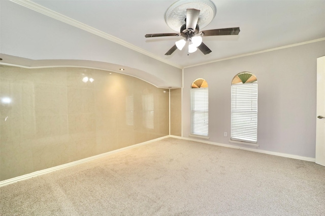 carpeted empty room featuring ceiling fan and ornamental molding