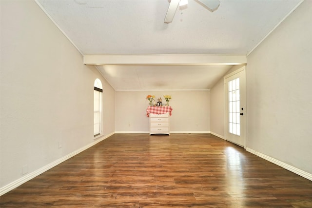 interior space with ceiling fan, dark wood-type flooring, and lofted ceiling with beams