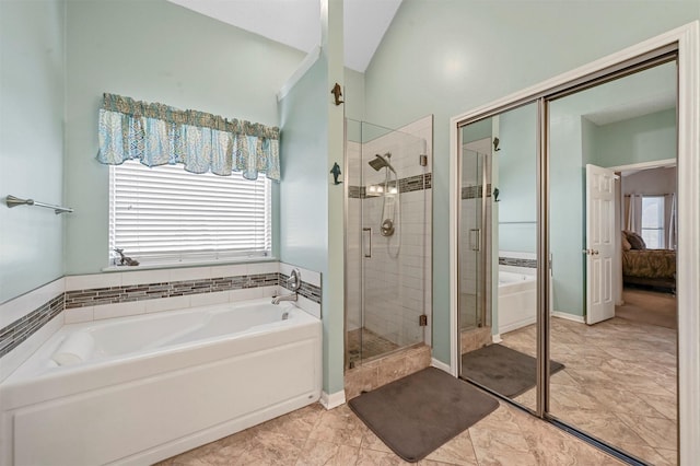 bathroom with tile patterned flooring, lofted ceiling, and shower with separate bathtub