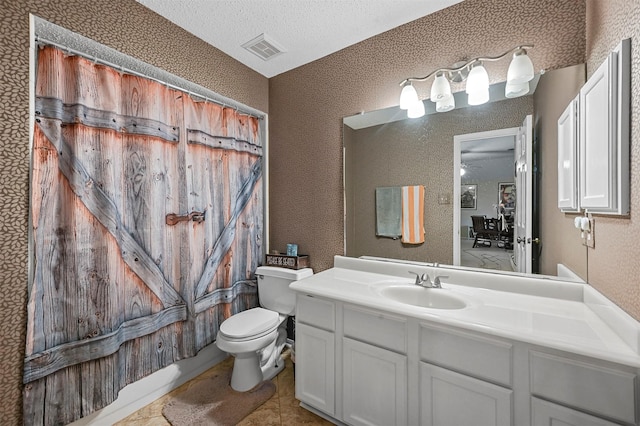 full bathroom with shower / bathtub combination with curtain, tile patterned flooring, a textured ceiling, toilet, and vanity