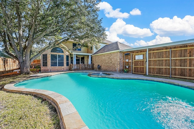 view of pool with an in ground hot tub