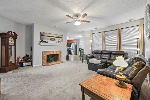 carpeted living room with a fireplace, a textured ceiling, and ceiling fan with notable chandelier