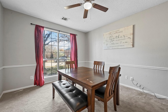 dining area with carpet flooring, a textured ceiling, plenty of natural light, and ceiling fan