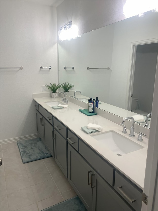 bathroom featuring toilet, vanity, and tile patterned floors