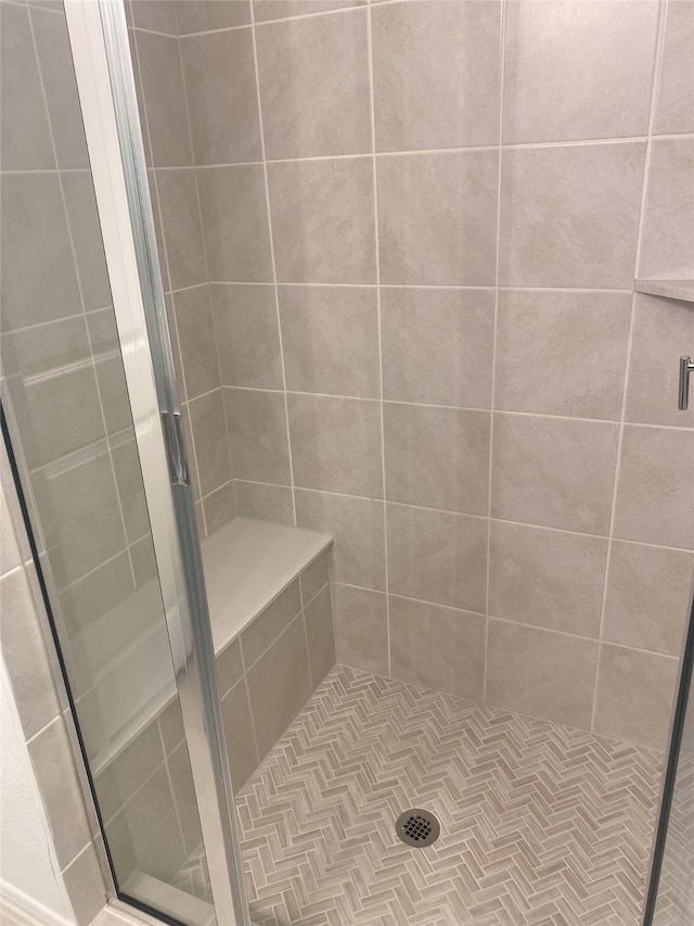 bathroom with a shower with door