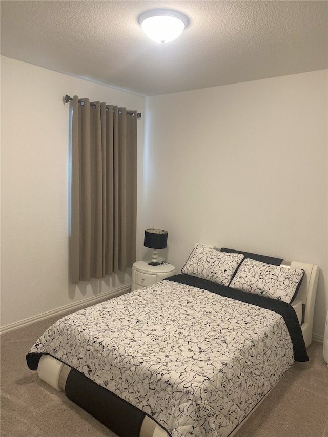 carpeted bedroom featuring a textured ceiling