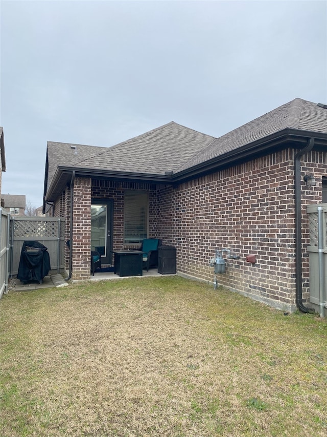 back of property featuring outdoor lounge area, a yard, and a patio