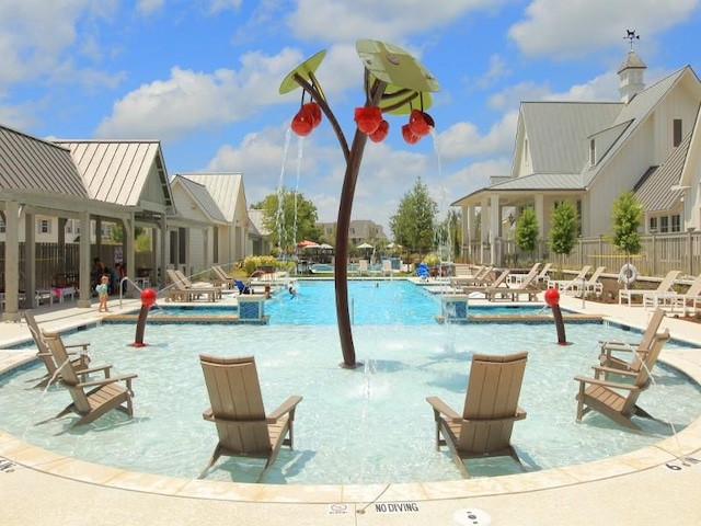 view of pool with a patio area and pool water feature